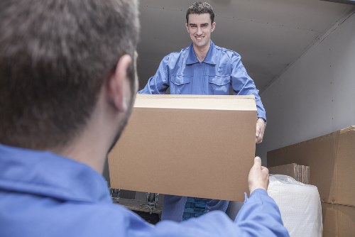 Furniture collection team handling bulky items in a Kentishtown home