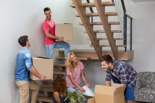 Commercial removal team moving office furniture in Kentishtown