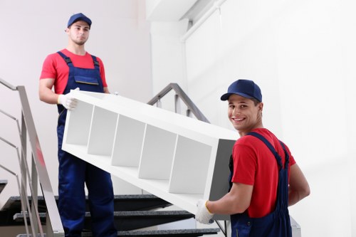 Man and van removals team loading furniture in Kentishtown street