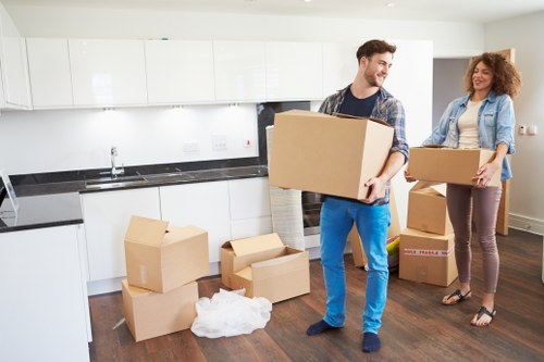 Movers carrying furniture through a narrow hallway